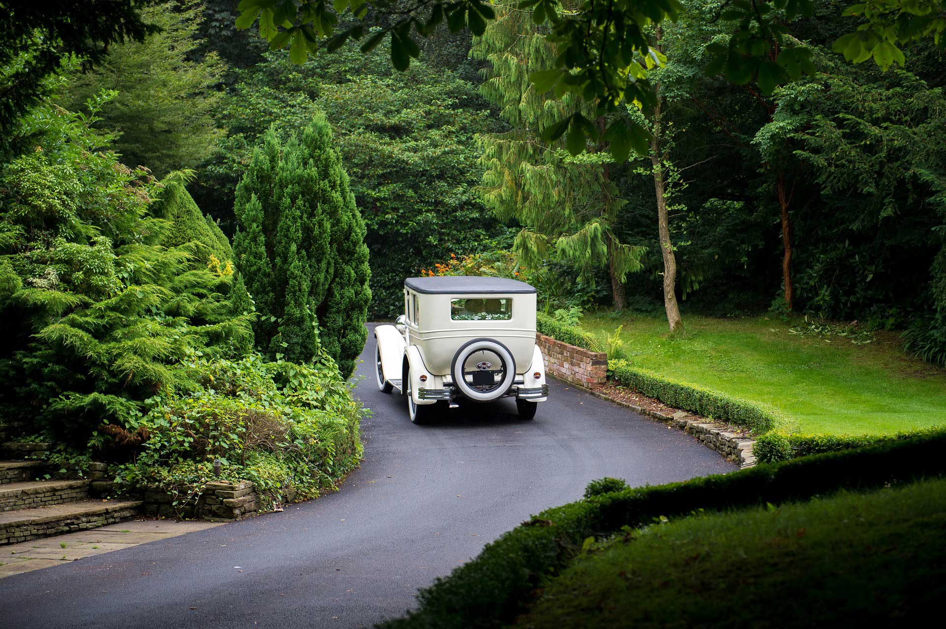 White wedding car driving away