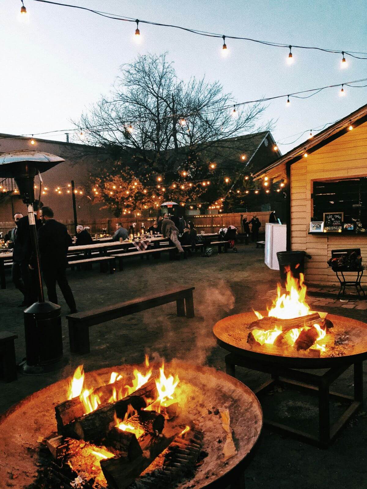 firepits at a venue with festoon lighting